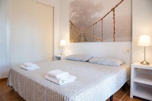 a bedroom with a bed with towels on it at Heavenly Homes Mojcar 93 in Mojácar +37 photos