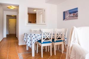 a dining room with a table and four chairs at Heavenly Homes Mojcar 93 in Mojácar
