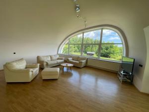 a large living room with a large window at Sluneční apartmán in Turnov