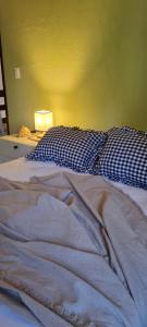 ein Bett mit einer blauen und weißen Decke und einer Lampe in der Unterkunft Casa do Bougainvillea Mundaú-Trairi-Ce in Mundaú + 30 Fotos