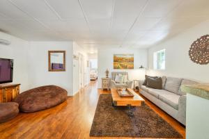 a living room with a couch and a table at Charming Milk Barn Home on Vineyard Estate in Forestville