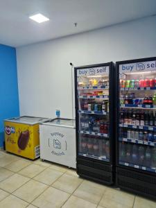 a store with two refrigerators in a room with drinks at Flat com Vista Panorâmica in Bauru