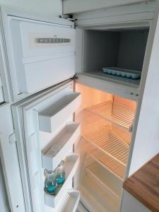 an empty refrigerator with its door open with drinks in it at 6 Schlafplätze - Zentral, Balkon, Parkplatz, Küche in Bocholt