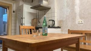 a green bottle sitting on top of a wooden table at Budget # MONTEURHAUS # Sugenheim in Sugenheim