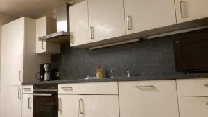 a kitchen with white cabinets and a sink at Budget # MONTEURHAUS # Sugenheim in Sugenheim