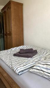 a unmade bed with a blanket on top of it at Budget # MONTEURHAUS # Sugenheim in Sugenheim