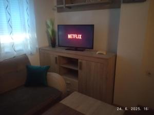 a television sitting on a cabinet with a night light on it at Apartman Dijana in Livno