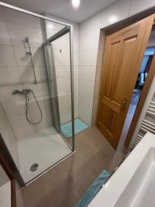 a bathroom with a shower with a glass door at Ferienhof Mitterbauer in Mondsee