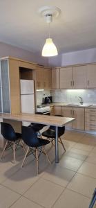 a kitchen with a large wooden table and chairs at Grey House in Prinos