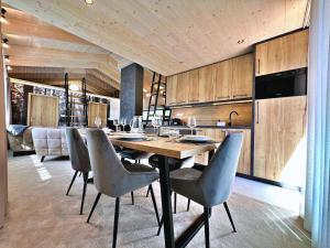 a kitchen with a dining table and chairs at Malino Resort & Residences - Ski and Bike Apartments in Ružomberok