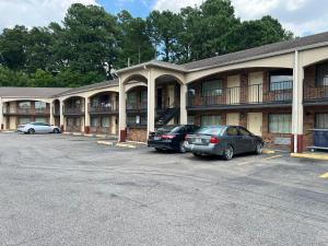 a building with two cars parked in a parking lot at crown inn in Memphis