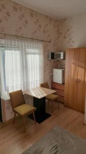 a kitchen with a table and chairs in a room at Pokoje Gościnne Łeba u Michała in Łeba