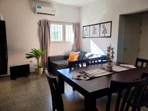 a living room with a table and a couch at Casa Oliva in Tinogasta