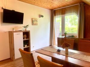 a dining room with a table and a large window at Balatonföldvar Centrum Apartmanok 2 in Balatonföldvár