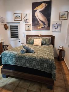 a bedroom with a bed with a bird on it at Private pool large yard minutes to beach or ferry in Ceiba