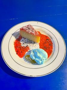 a white plate with a piece of cake and sauce at Villa KAMBUSA appartamento SOFIA in Las Galeras