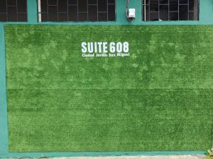 a green lawn with a sign that reads surf fields sanilimum at Suite 608 Ciudad Jardín San Miguel in San Miguel +4 photos