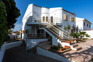 a white house with stairs in front of it at Villa Mar Rompido in El Rompido
