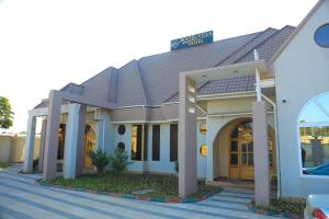 a house with a street sign on top of it at Rostel Villa Hotel in Mbeya