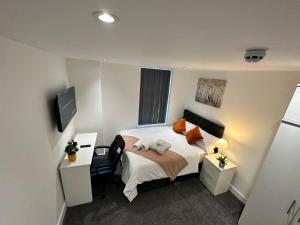 a small bedroom with a bed and a tv at Regent Cosy in Coventry
