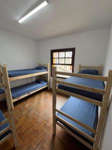 a room with three bunk beds and a window at Ana Rosa estação Av Paulista in Sao Paulo +10 photos