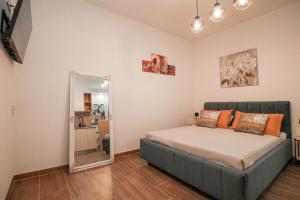 a bedroom with a bed and a mirror at Apartman Lamanova in Rovinj