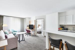 a living room with a kitchen and a living room at Staybridge Suites Peoria Downtown by IHG in Peoria