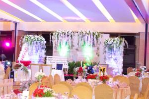 a banquet hall with tables and chairs and flowers at Manila Grand Opera Hotel in Manila