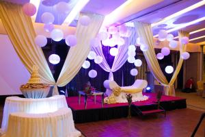 a room with pink and white balloons and a table at Manila Grand Opera Hotel in Manila