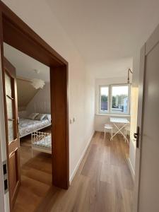 a room with a door leading to a bedroom at Wiatrakówka in Kosewo