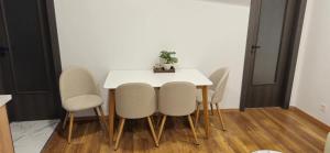 a dining room with a white table and chairs at Apartments Dubrava 5 in Zagreb