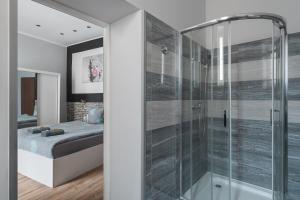 a bedroom with a glass shower with a bed at 70s Hostel in Krakow +195 photos