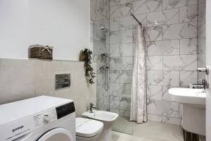 a bathroom with a toilet and a sink at Sika Sunny Apartment - Free private parking & Balcony in Arad +18 photos