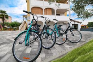 three bikes parked in front of a building at Apartman Lamanova in Rovinj