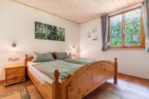 a bedroom with a wooden bed in a room at Igelbau in Wolfach