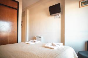 Postel nebo postele na pokoji v ubytování Hotel Carlos Paz