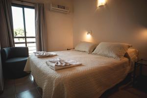 Postel nebo postele na pokoji v ubytování Hotel Carlos Paz