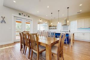 a kitchen and dining room with a wooden table and chairs at Vacation Station in Canyon Lake +17 photos