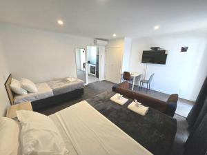 a hotel room with two beds and a flat screen tv at Motel 22 in Lower Hutt