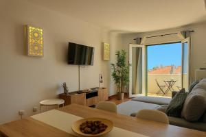 a living room with a couch and a table at Grupo Morgado - Quinta do Morgado - Morgado Privilege in Tavira