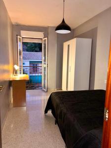 a bedroom with a bed and a door to a balcony at Piso amplio y luminoso ideal para pasar unos días in Madrid