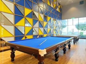 a pool table in a room with a wall at Eco Residence By CNN in Kuala Lumpur