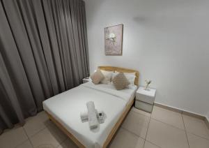 a bedroom with a bed with a cross on it at Eco Residence By CNN in Kuala Lumpur +14 photos