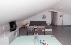 a living room with a couch and a table at Apartment Maslenica in Jasenice