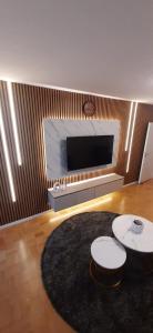 a living room with two tables and a fireplace at Lian am See in Friedrichshafen