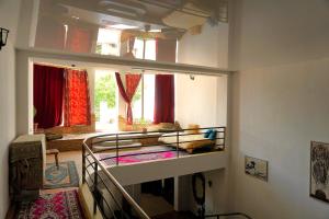 a bedroom with a bunk bed in a room with windows at Pospolita Guest House in Kutaisi +79 photos