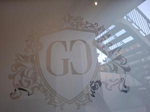 a shield with the letter c on the side of a building at Ognissanti Rooms in Acireale