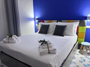 a bedroom with a large bed with towels on it at Ognissanti Rooms in Acireale