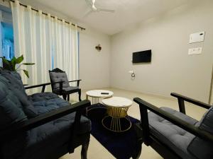 a living room with a couch and a table at Coastal Hideout 1bhk Colva anirah Homes in Colva