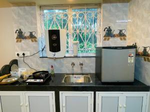 a kitchen with a sink and a window at Coastal Hideout 1bhk Colva anirah Homes in Colva